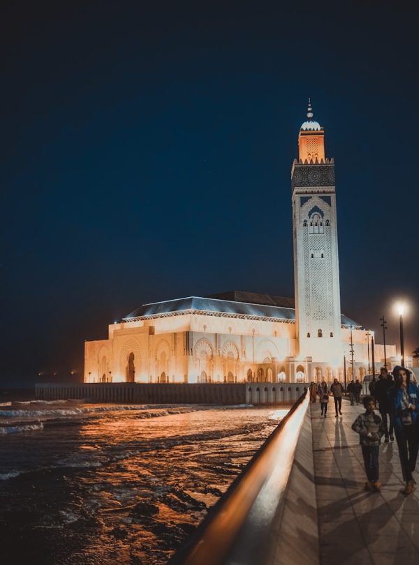 people walking near brown concrete building during night time